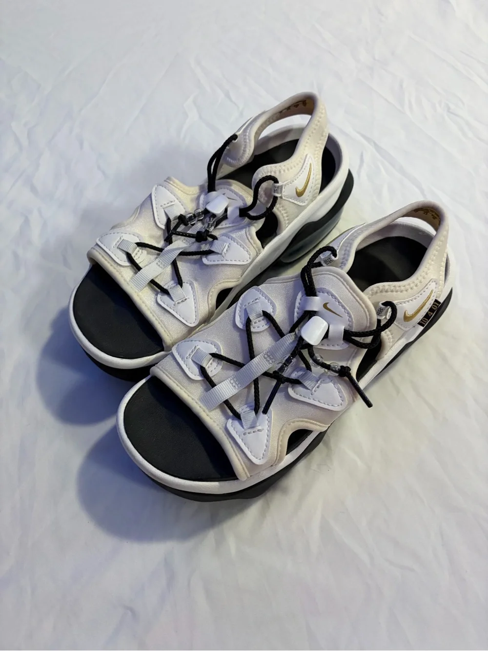Nike Women’s White and Black Sandals with Gold Swoosh